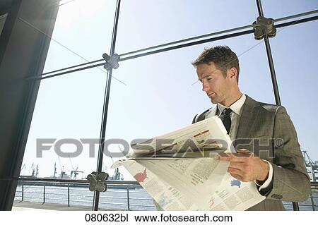 businessman reading newspaper in front of window View Large Photo Image Stock Image - businessman reading newspaper in front of window. Fotosearch