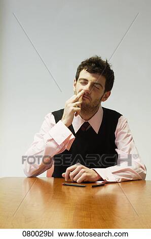 businessman sitting at conference table picking his nose View Large Photo Image Stock Image - businessman sitting at conference table picking his nose. Fotosearch