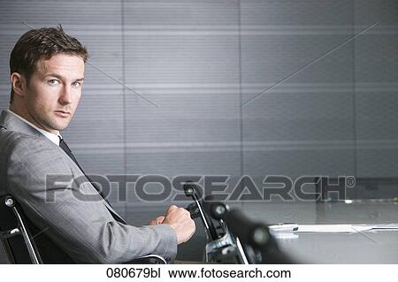 businessman sitting at conference table in meeting room View Large Photo Image Stock Image - businessman sitting at conference table in meeting room. Fotosearch