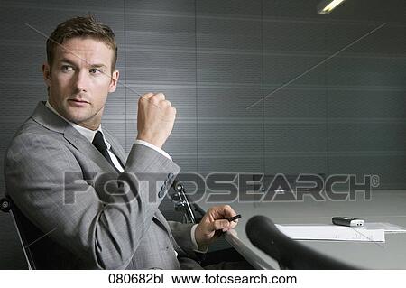 businessman sitting at conference table in meeting room View Large Photo Image Stock Image - businessman sitting at conference table in meeting room. Fotosearch
