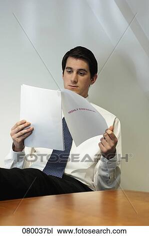 businessman sitting at desk with feet up reading document View Large Photo Image Stock Image - businessman sitting at desk with feet up reading document. Fotosearch