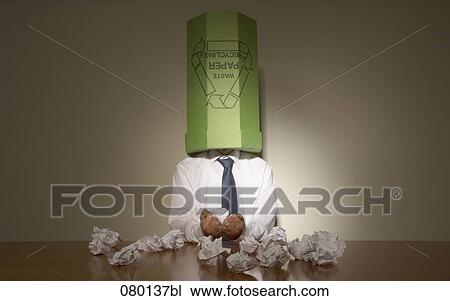 businessman sitting at untidy desk with wastebasket over his head View Large Photo Image Stock Image - businessman sitting at untidy desk with wastebasket over his head. Fotosearch