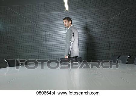businessman standing at conference table in meeting room View Large Photo Image Stock Image - businessman standing at conference table in meeting room. Fotosearch