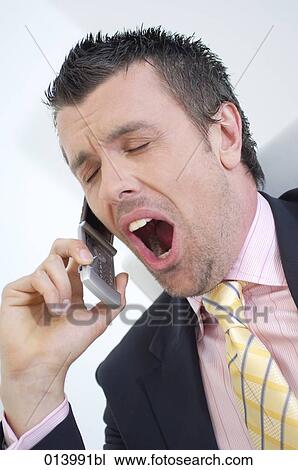 businessman yawning while talking on mobile phone View Large Photo Image Stock Image - businessman yawning while talking on mobile phone. Fotosearch