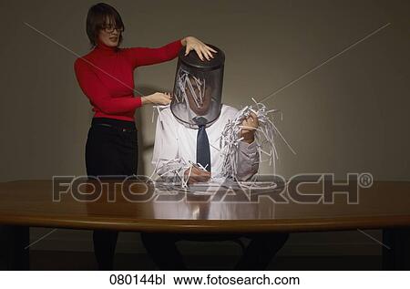 businesswoman emptying wastebasket over her colleague View Large Photo Image Stock Image - businesswoman emptying wastebasket over her colleague. Fotosearch