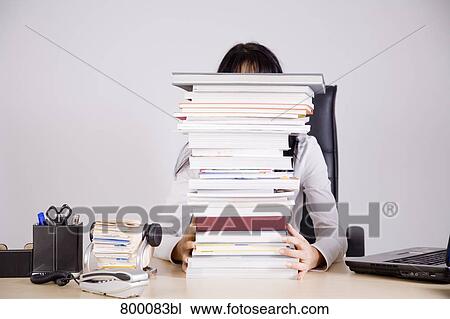 businesswoman sitting on desk hidden behind pile of books View Large Photo Image Stock Image - businesswoman sitting on desk hidden behind pile of books. Fotosearch