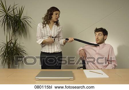 businesswoman threatening to cut male colleague´s tie View Large Photo Image Stock Image - businesswoman threatening to cut male colleague´s tie. Fotosearch