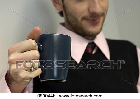 close-up of businesman holding mug View Large Photo Image Stock Image - close-up of businesman holding mug. Fotosearch