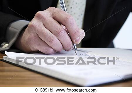 close-up of businessman making notes in his journal View Large Photo Image Stock Image - close-up of businessman making notes in his journal. Fotosearch