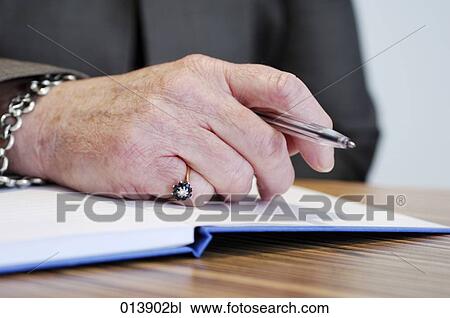 close-up of elderly executive´s hand holding pen View Large Photo Image Stock Image - close-up of elderly executive´s hand holding pen. Fotosearch