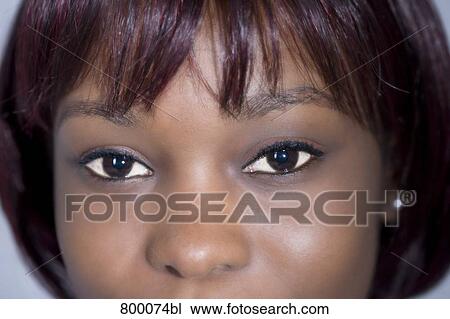 Stock Image - close-up of eyes of young black woman. Fotosearch