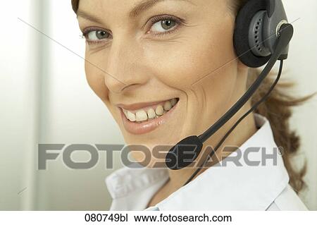 Stock Image - close-up of female call center agent. Fotosearch