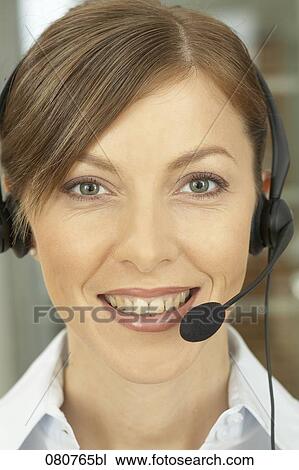 Stock Image - close-up of female call center agent. Fotosearch