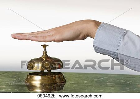 close-up of female hand ringing hotel reception bell View Large Photo Image Stock Image - close-up of female hand ringing hotel reception bell. Fotosearch