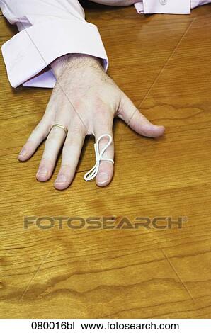 close-up of male hand with knot tied around index finger View Large Photo Image Stock Image - close-up of male hand with knot tied around index finger. Fotosearch