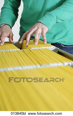 close-up of man going through files in filing cabinet View Large Photo Image Stock Image - close-up of man going through files in filing cabinet. Fotosearch