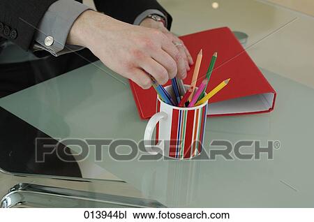 Stock Image - close-up of man taking pencils. Fotosearch
