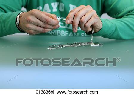 close-up of office worker playing with paper clips View Large Photo Image Stock Image - close-up of office worker playing with paper clips. Fotosearch