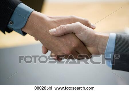 close-up of two businessmen shaking hands View Large Photo Image Stock Image - close-up of two businessmen shaking hands. Fotosearch