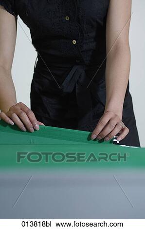 close-up of woman going through files in filing cabinet View Large Photo Image Stock Image - close-up of woman going through files in filing cabinet. Fotosearch