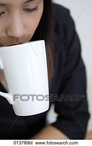 close-up of young asian woman drinking tea View Large Photo Image Stock Image - close-up of young asian woman drinking tea. Fotosearch