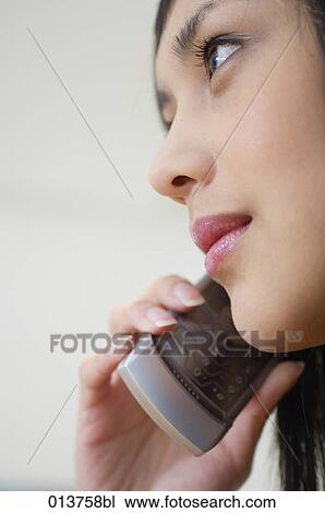 close-up on face of asian woman listening to cellular phone View Large Photo Image Stock Image - close-up on face of asian woman listening to cellular phone. Fotosearch