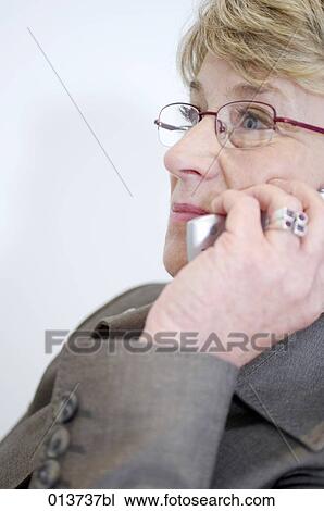 close-up portrait of mature woman talking on cellular phone View Large Photo Image Stock Image - close-up portrait of mature woman talking on cellular phone. Fotosearch