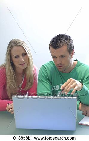couple looking at notebook computer, man pointing to screen View Large Photo Image Stock Image - couple looking at notebook computer, man pointing to screen. Fotosearch