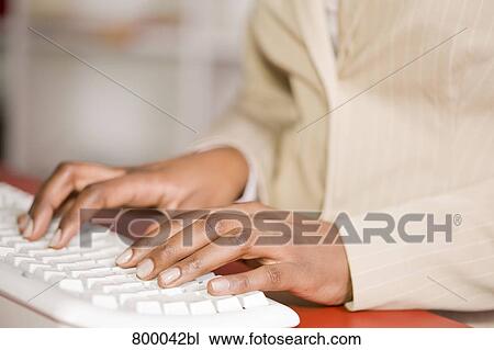 detail of black office worker typing on computer keyboard View Large Photo Image Stock Image - detail of black office worker typing on computer keyboard. Fotosearch