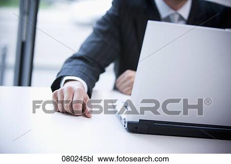 detail of businessman at desk with laptop computer View Large Photo Image Stock Image - detail of businessman at desk with laptop computer. Fotosearch