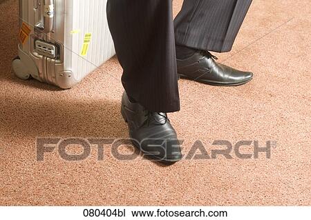 detail of businessman sitting on suitcase View Large Photo Image Stock Image - detail of businessman sitting on suitcase. Fotosearch