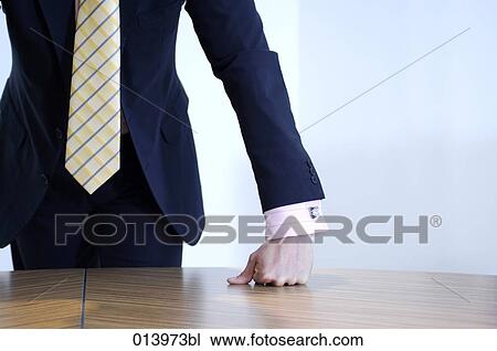 Stock Image - detail of smart dressed executive putting hands on table. Fotosearch