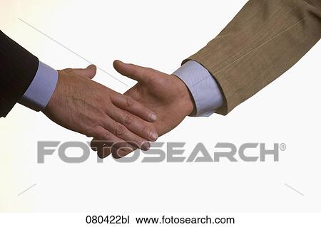 Stock Image - detail of two businessmen shaking hands. Fotosearch