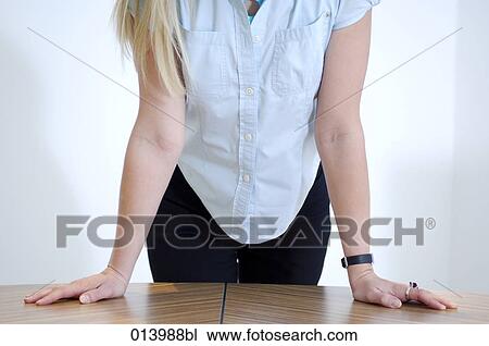 detail of woman leaning on table in office View Large Photo Image Stock Image - detail of woman leaning on table in office. Fotosearch