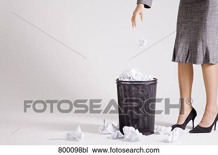 detail of young businesswoman throwing paper in wastebasket View Large Photo Image Stock Image - detail of young businesswoman throwing paper in wastebasket. Fotosearch