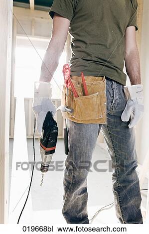 detail of young man with electric drill and other construction tools View Large Photo Image Stock Image - detail of young man with electric drill and other construction tools. Fotosearch