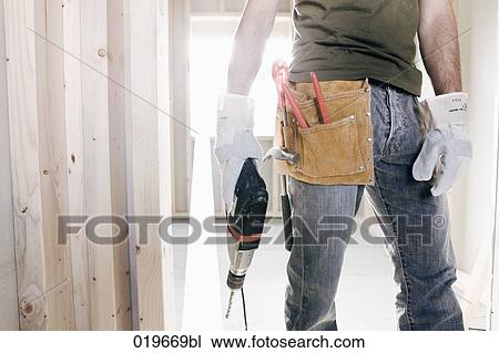 detail of young man with electric drill and other construction tools View Large Photo Image Stock Image - detail of young man with electric drill and other construction tools. Fotosearch