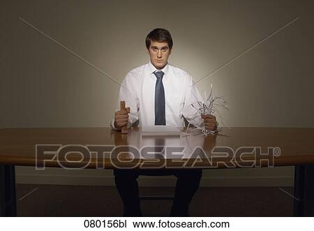 determined businessman at desk holing pencils and shredded paper View Large Photo Image Stock Image - determined businessman at desk holing pencils and shredded paper. Fotosearch