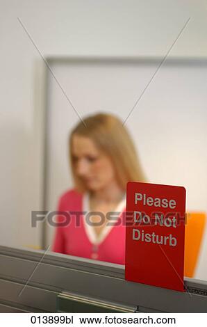 Stock Image - Do not disturb sign with female executive in background. Fotosearch