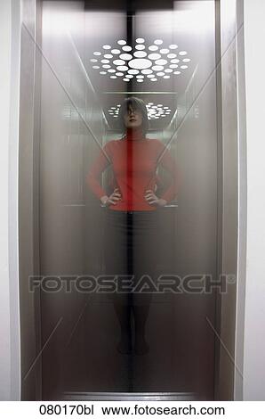 double exposure of businesswoman standing in elevator in office building View Large Photo Image Stock Image - double exposure of businesswoman standing in elevator in office building. Fotosearch