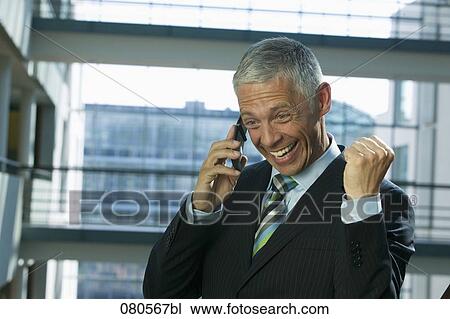 excited mature businessman listening to mobile phone View Large Photo Image Stock Image - excited mature businessman listening to mobile phone. Fotosearch