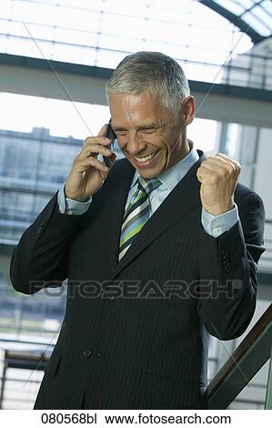 excited mature businessman listening to mobile phone View Large Photo Image Stock Image - excited mature businessman listening to mobile phone. Fotosearch
