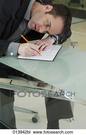 executive doodling in his book during a meeting View Large Photo Image Stock Image - executive doodling in his book during a meeting. Fotosearch