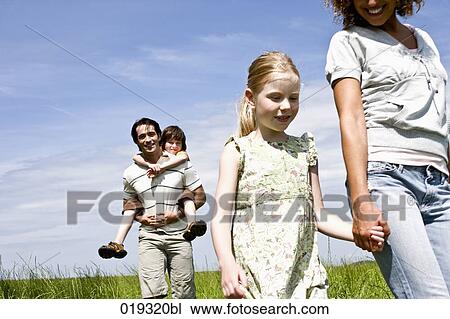 family walking on meadow View Large Photo Image Stock Image - family walking on meadow. Fotosearch