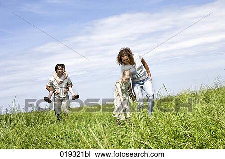 family walking on meadow View Large Photo Image Stock Image - family walking on meadow. Fotosearch