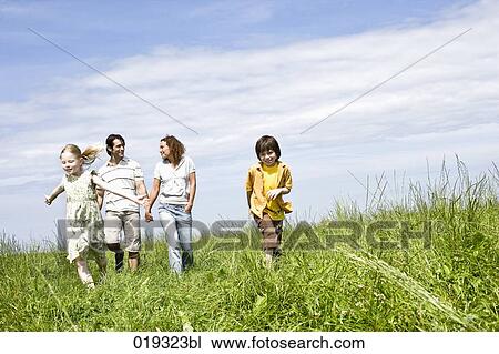 family walking on meadow View Large Photo Image Stock Image - family walking on meadow. Fotosearch