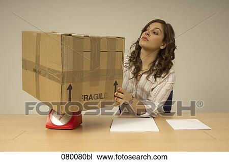 female office worker putting package on red scales View Large Photo Image Stock Image - female office worker putting package on red scales. Fotosearch