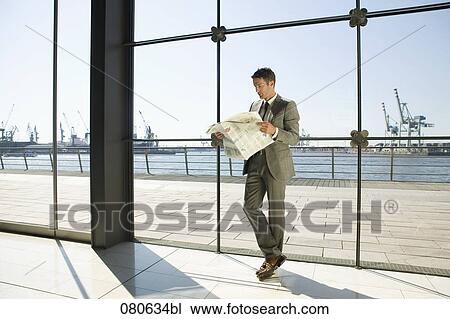 full body portrait of businessman reading newspaper in front of window View Large Photo Image Stock Image - full body portrait of businessman reading newspaper in front of window. Fotosearch