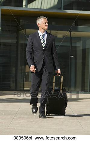 full body portrait of mature businessman with carry-on suitcase View Large Photo Image Stock Image - full body portrait of mature businessman with carry-on suitcase. Fotosearch