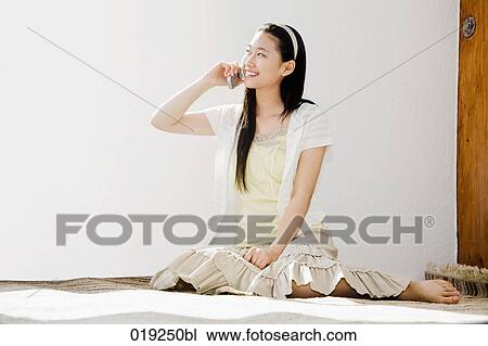 full body portrait of young japanese girl sitting on floor talking on mobile phone View Large Photo Image Stock Image - full body portrait of young japanese girl sitting on floor talking on mobile phone. Fotosearch